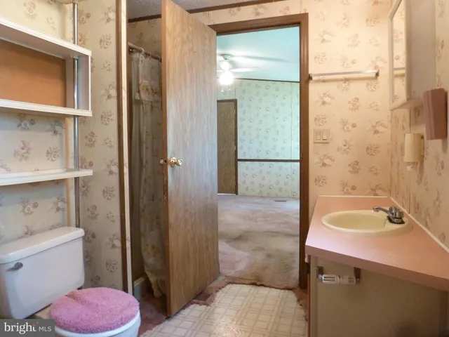 en empty room with windows and fan