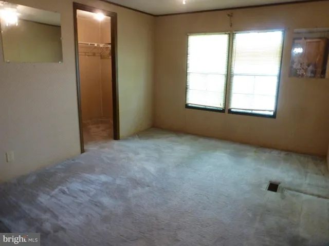 a view of a house with a yard and deck