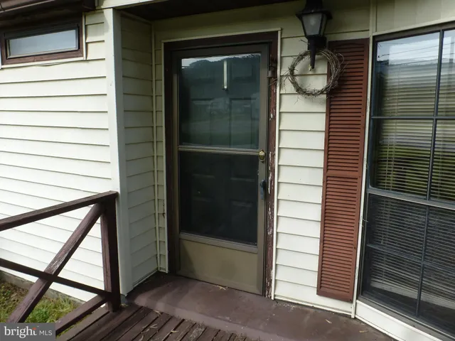 a view of a house with a yard and large trees
