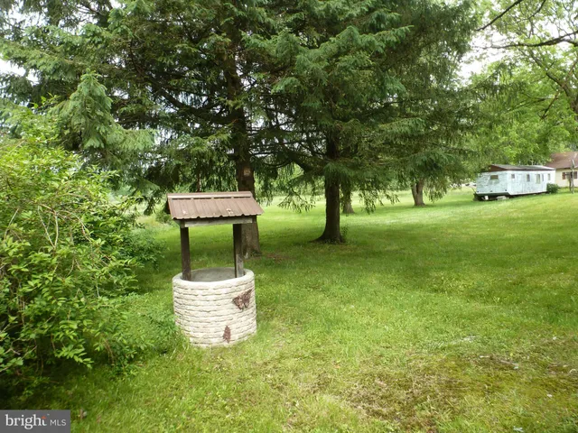 a view of a small house with a yard