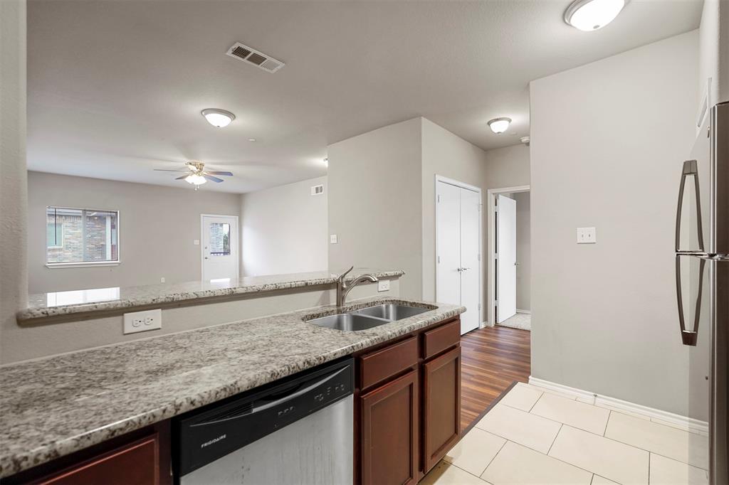 514 East Hazelwood Street, Unit A Princeton, TX 75407 - Photo 8 of 19 a bathroom with a granite countertop sink and a mirror