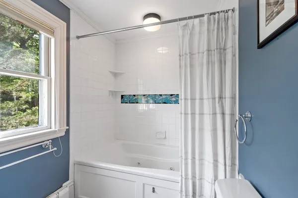 a bathroom with a shower and a window