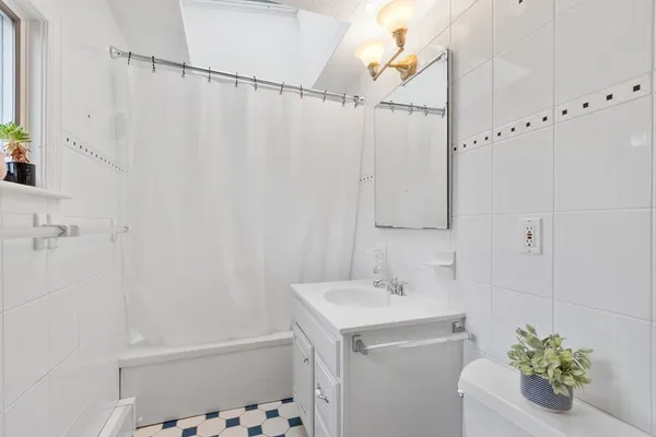 a bathroom with a sink a vanity and a shower