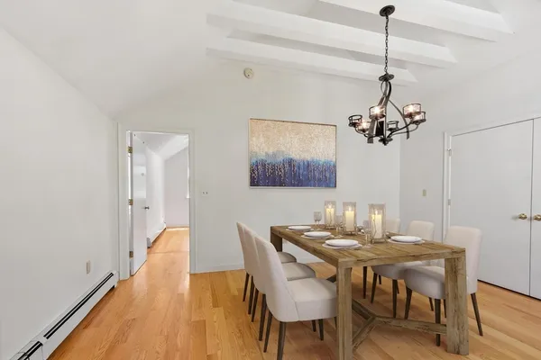 a dining room with furniture and chandelier