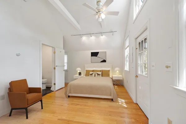 a bedroom with a bed couch and window