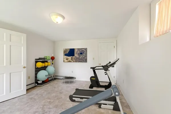 a room with gym equipment and windows