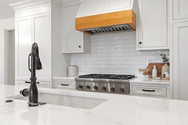 a kitchen with granite countertop a stove and a sink