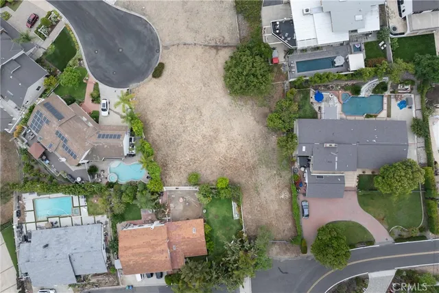 an aerial view of a house with outdoor space and street view