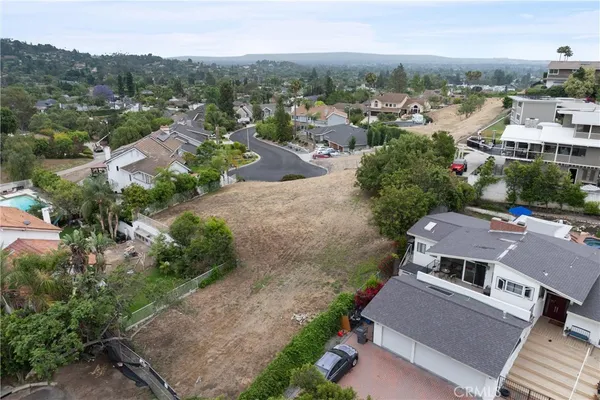 an aerial view of multiple houses with yard