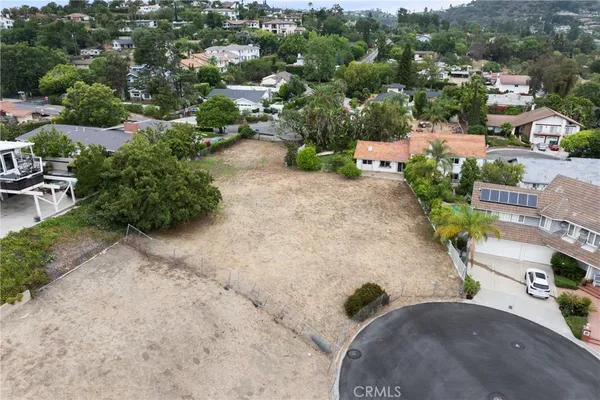 an aerial view of a house with garden space and street view