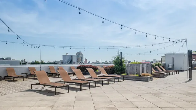 a view of a terrace with furniture and lounge chairs