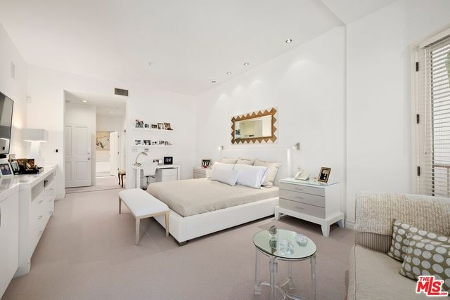 a spacious bedroom with two beds and a couch