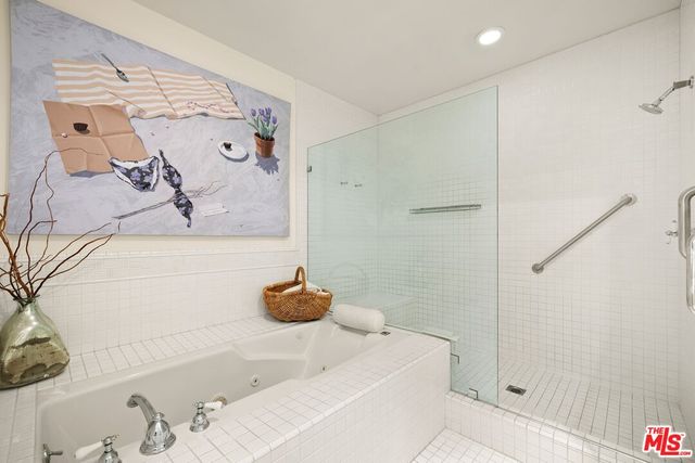 a bathroom with a tub and shower
