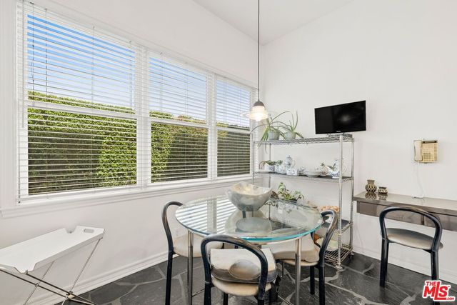 a view of a dining room with furniture and window