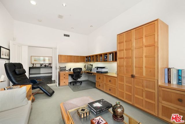 a room with furniture gym equipment and a large window