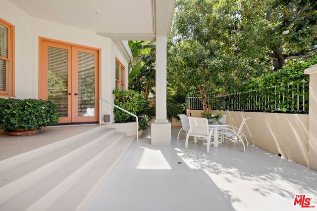 a view of a patio with table and chairs and potted plants