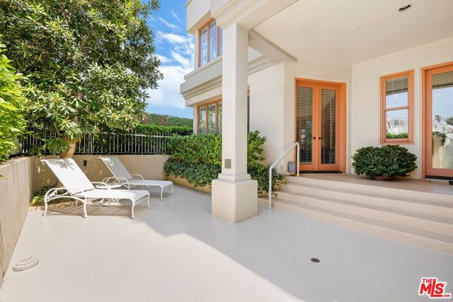 a view of a patio with couches and potted plants