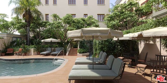 an outdoor space with swimming pool and furniture
