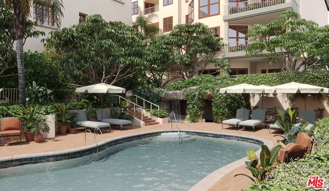 a view of a swimming pool with a table and chairs under an umbrella