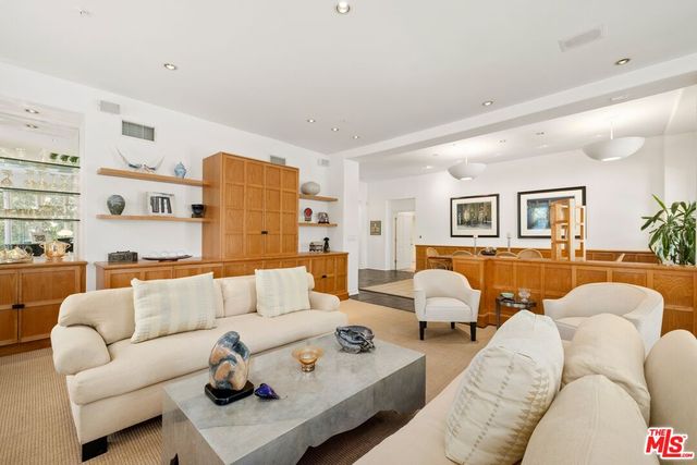 a living room with furniture and kitchen view