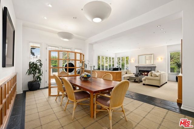 a view of a dining room with furniture and a potted plant