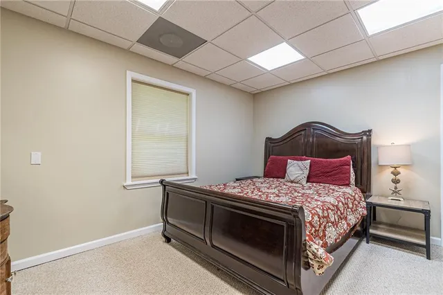 a room with painting on the wall and a dresser