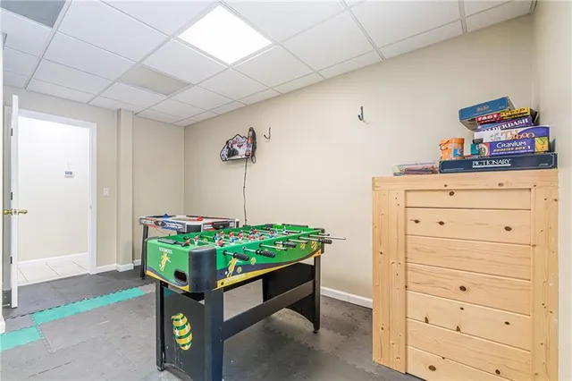 a room with furniture on wooden floor and windows