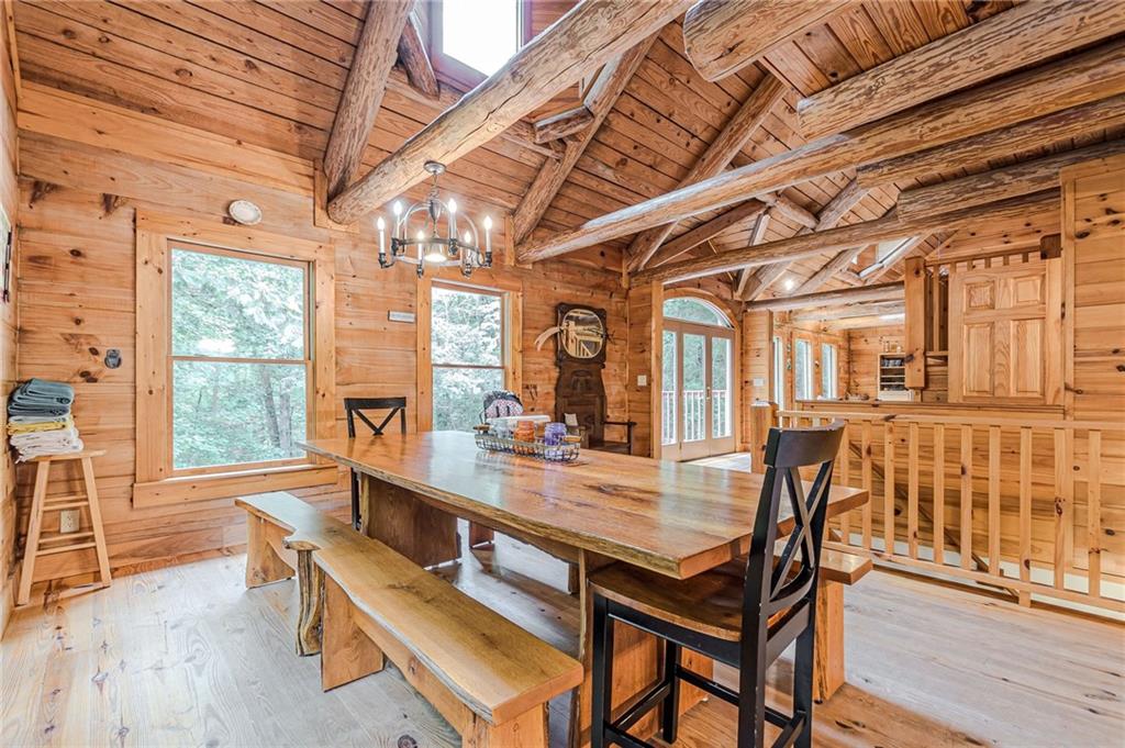 45 Chestatee River Ridge Dahlonega, GA 30533 - Photo 31 of 74 a dining room with wooden floor a chandelier a wooden table and chairs