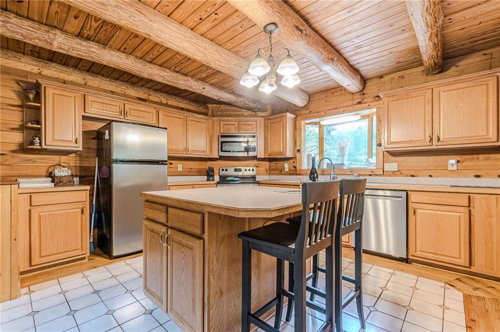 45 Chestatee River Ridge Dahlonega, GA 30533 - Photo 34 of 74 a kitchen with stainless steel appliances granite countertop a refrigerator a stove a sink and dishwasher with a dining table