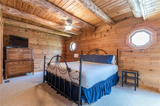a view of a patio with table and chairs a barbeque with wooden floor and fence