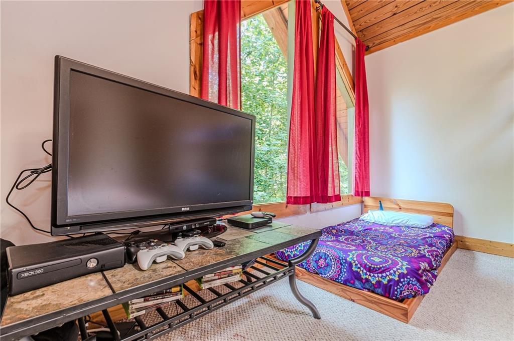 45 Chestatee River Ridge Dahlonega, GA 30533 - Photo 57 of 74 a living room with a bed and a flat screen tv