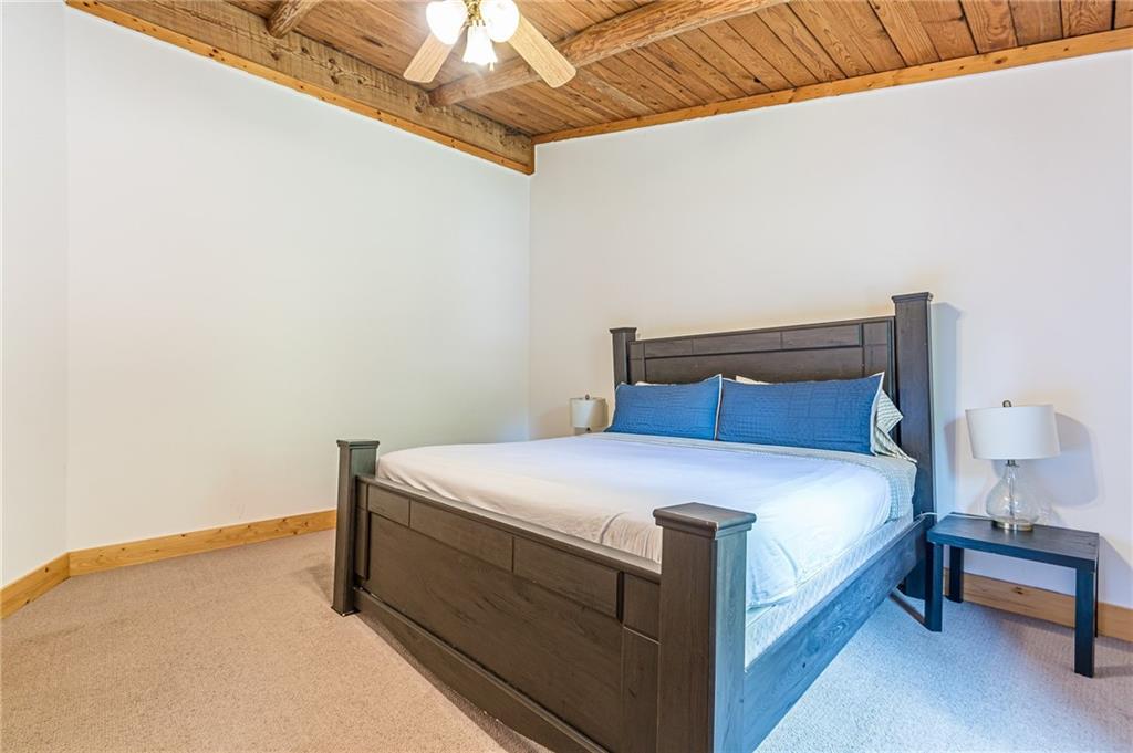 45 Chestatee River Ridge Dahlonega, GA 30533 - Photo 62 of 74 a bed sitting in a bedroom next to a lamp