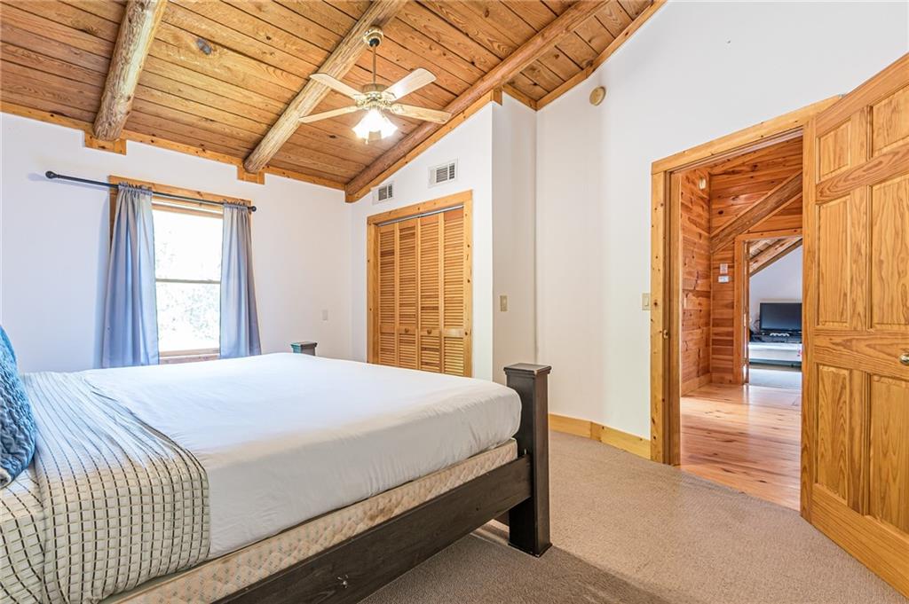 45 Chestatee River Ridge Dahlonega, GA 30533 - Photo 63 of 74 a bedroom with a large bed and a large window