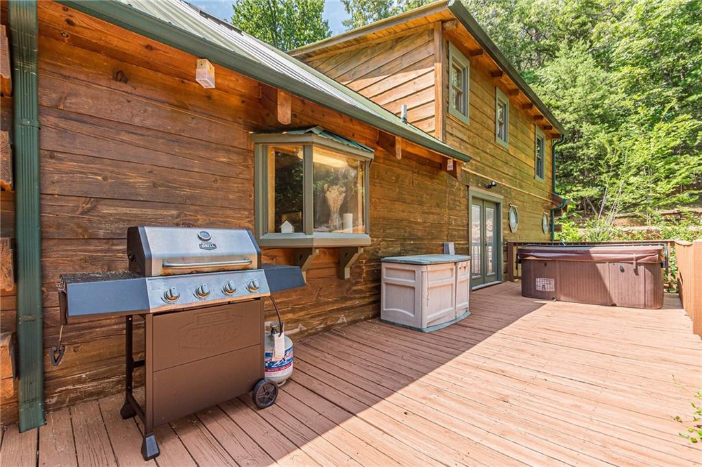 45 Chestatee River Ridge Dahlonega, GA 30533 - Photo 67 of 74 a view of a patio with table and chairs a barbeque with wooden floor and fence