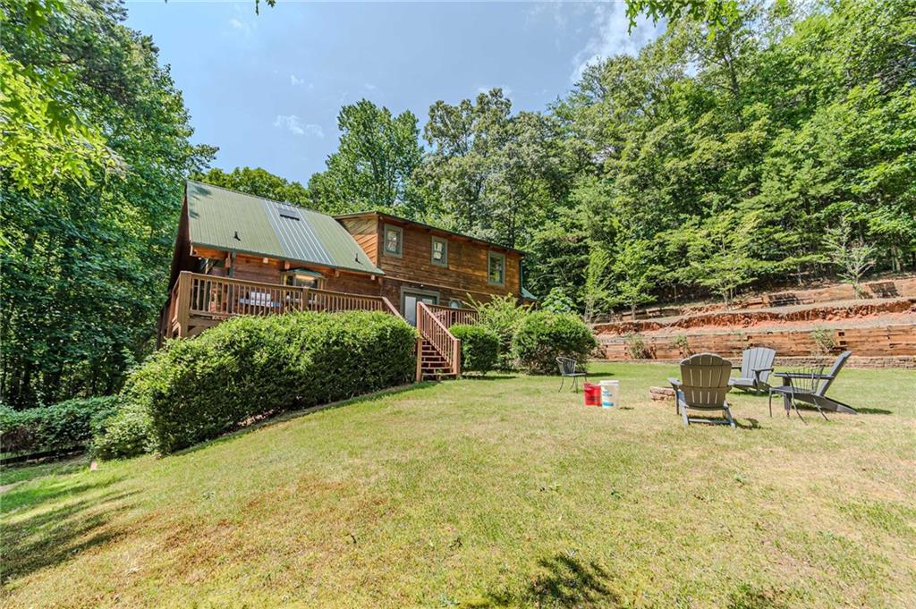 45 Chestatee River Ridge Dahlonega, GA 30533 - Photo 71 of 74 a view of table and chairs under an umbrella