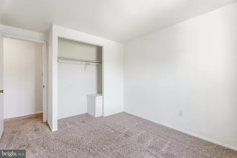 a spacious bedroom with a bed and a couch