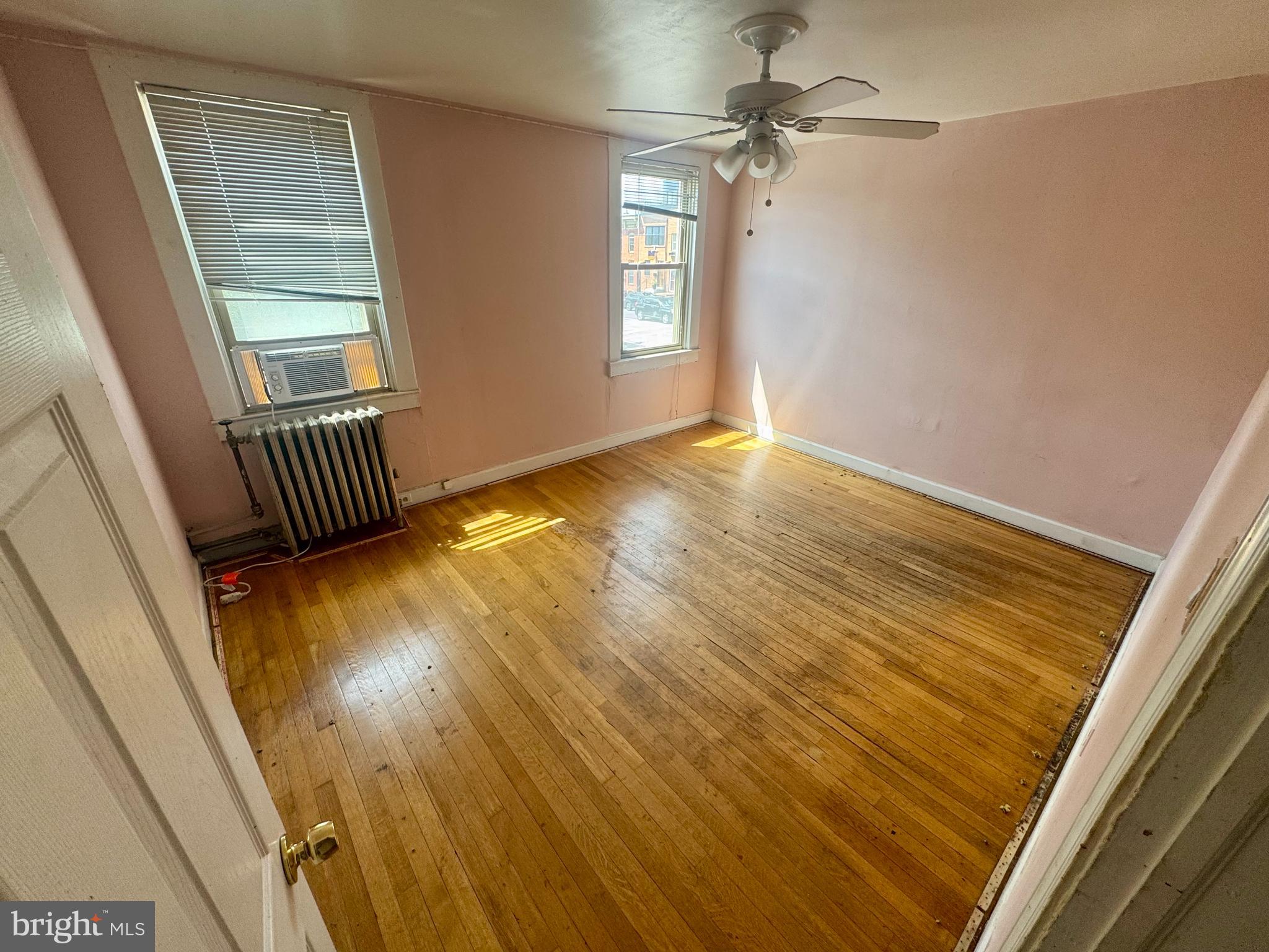 3301 Foster Avenue Baltimore, MD 21224 - Photo 13 of 19 a view of an empty room with wooden floor and a window