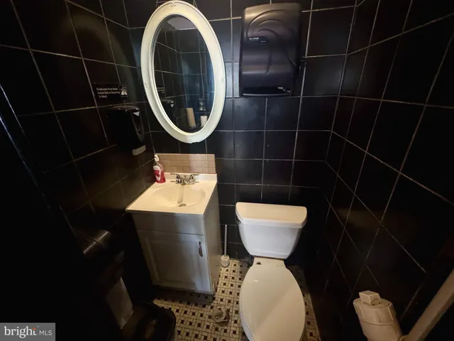 a kitchen with a sink a refrigerator a window and a counter top space