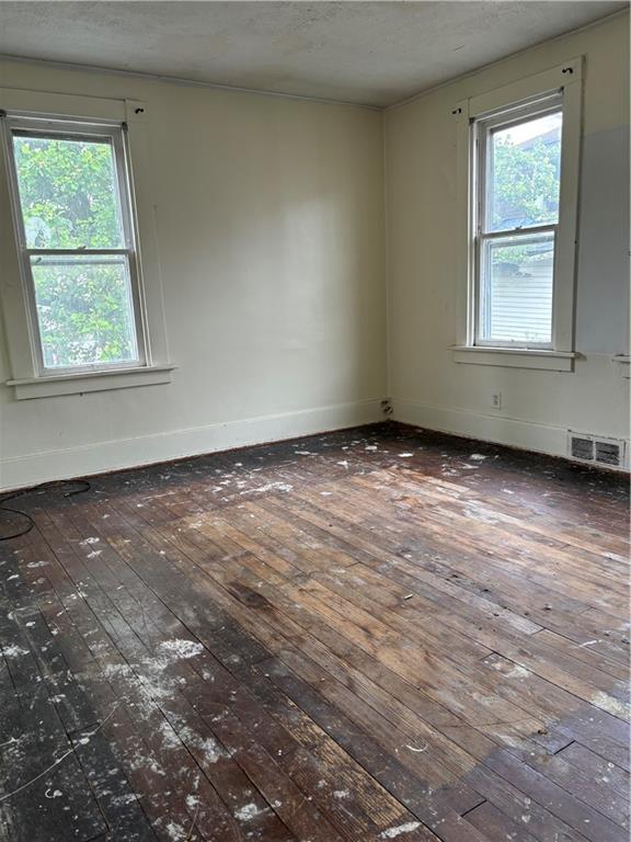306 Park Road Ambridge, PA 15003 - Photo 34 of 43 an empty room with wooden floor and windows