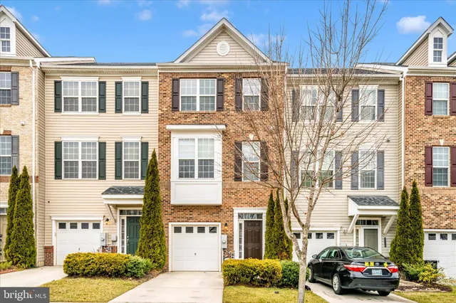 a front view of a residential apartment building with a yard