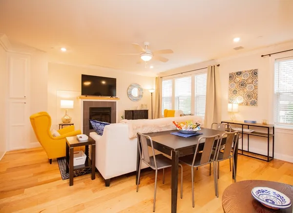 a dining room with furniture window and wooden floor