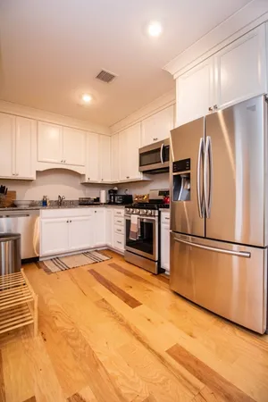 a kitchen with stainless steel appliances granite countertop a refrigerator stove a sink and a microwave