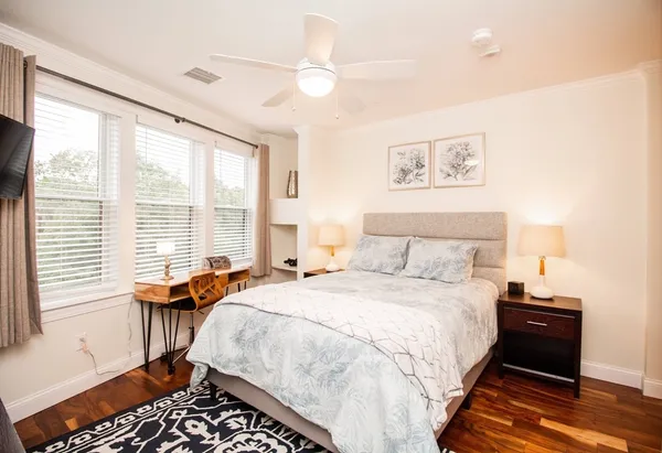 a bedroom with a bed and a table with window