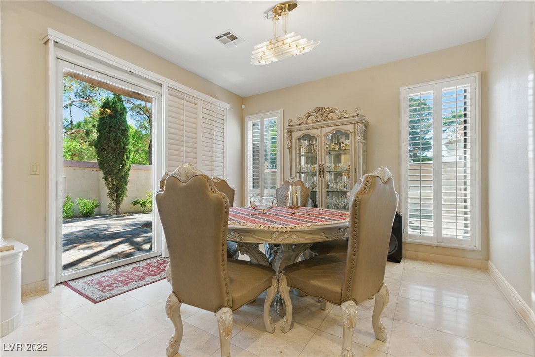 8215 Crow Valley Lane Las Vegas, NV 89113 - Photo 14 of 43 Dining space with baseboards and light tile patterned floors