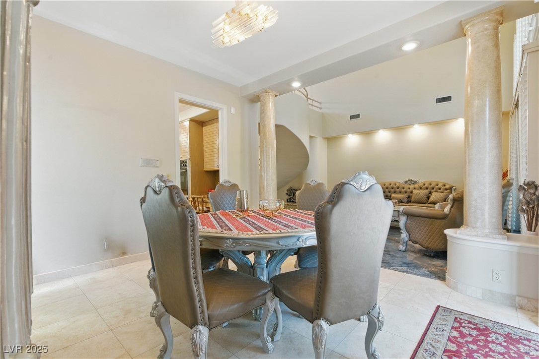 8215 Crow Valley Lane Las Vegas, NV 89113 - Photo 15 of 43 Dining room featuring decorative columns, recessed lighting, and light tile patterned flooring