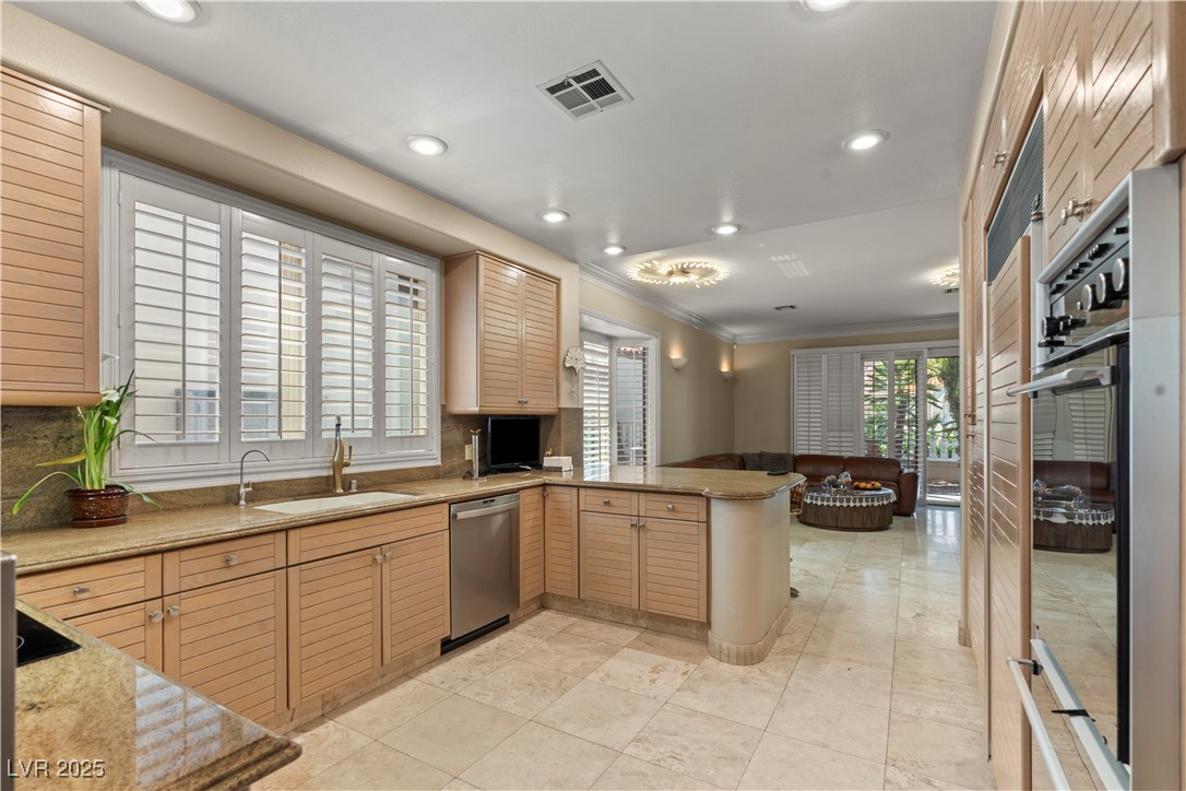 8215 Crow Valley Lane Las Vegas, NV 89113 - Photo 42 of 43 Kitchen with a peninsula, light stone counters, open floor plan, tasteful backsplash, and recessed lighting