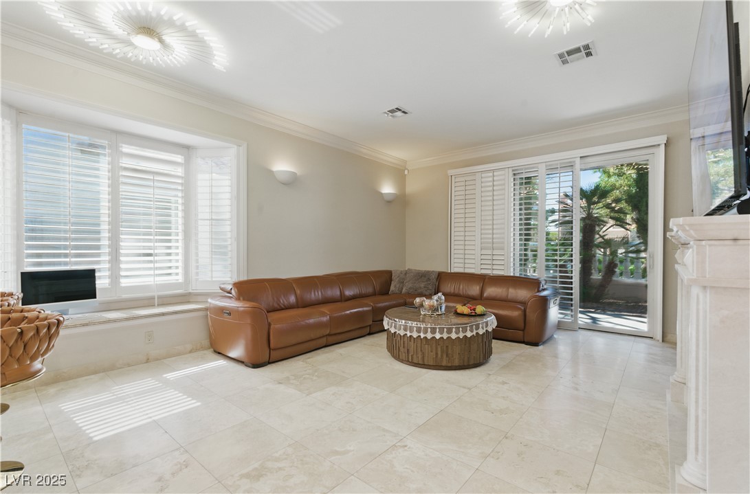 8215 Crow Valley Lane Las Vegas, NV 89113 - Photo 22 of 43 Living room featuring ornamental molding and a premium fireplace