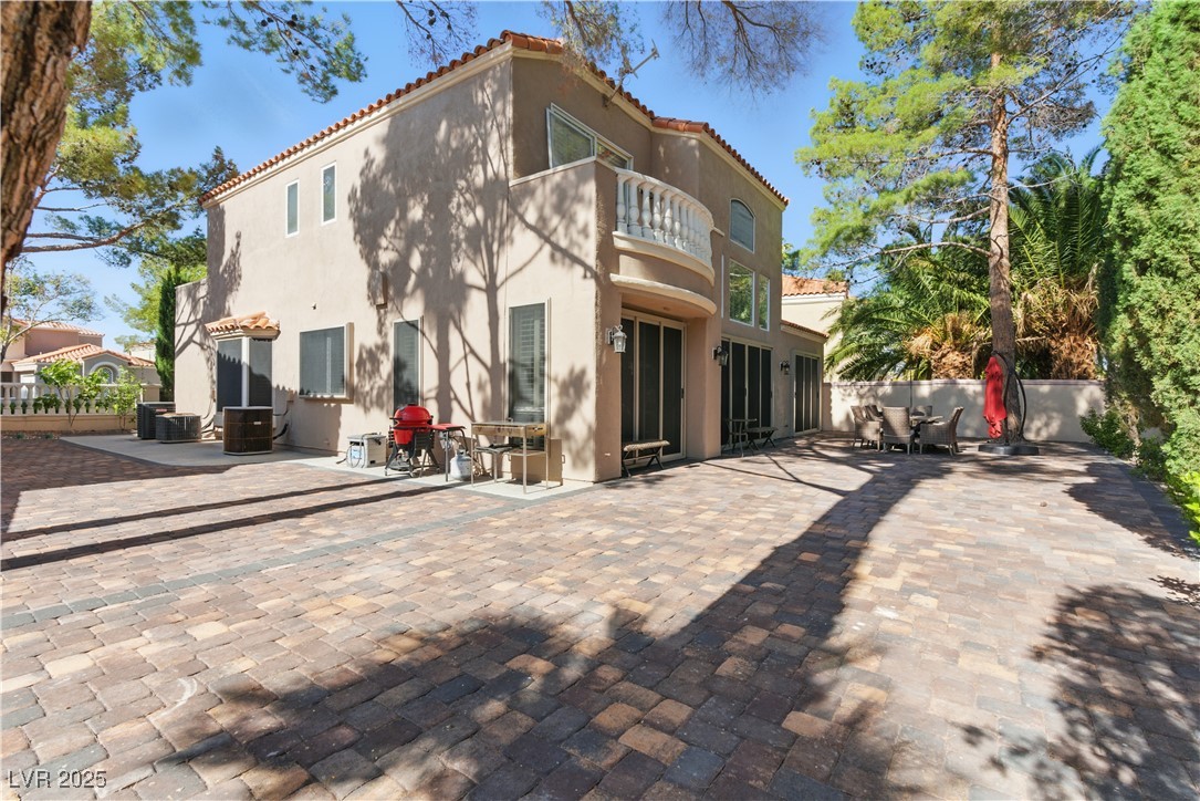8215 Crow Valley Lane Las Vegas, NV 89113 - Photo 24 of 43 Back of house with a balcony, a tile roof, and stucco siding