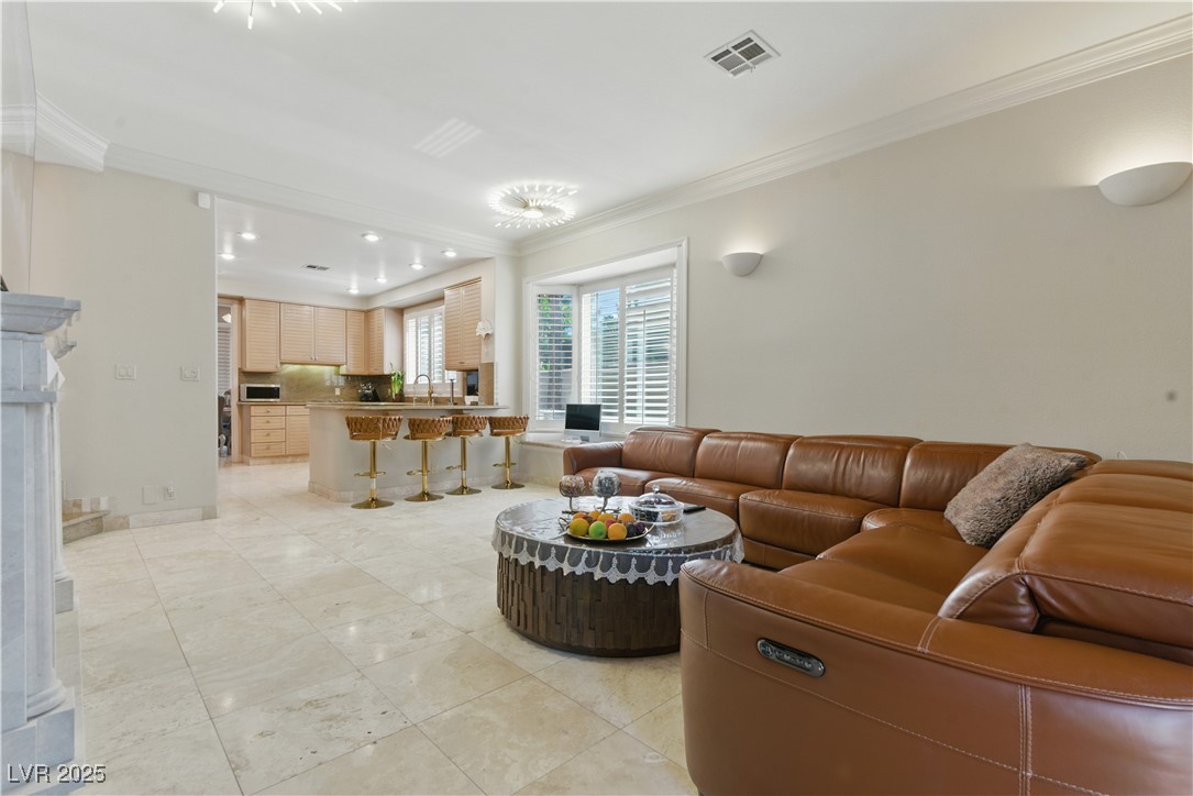 8215 Crow Valley Lane Las Vegas, NV 89113 - Photo 25 of 43 Living room featuring ornamental molding, recessed lighting, and light tile patterned floors