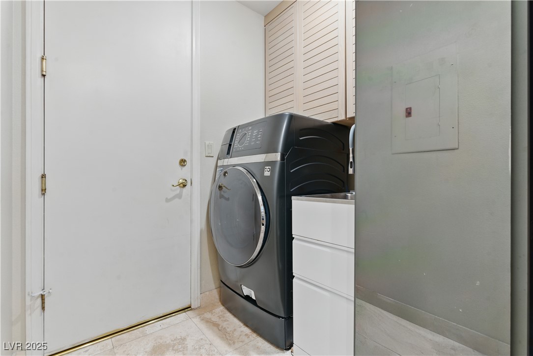 8215 Crow Valley Lane Las Vegas, NV 89113 - Photo 28 of 43 Laundry room featuring light tile patterned floors, cabinet space, and electric panel